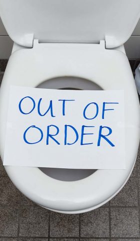 Written Text Out Of Order Message On Paper Over Toilet Bowl In Bathroom