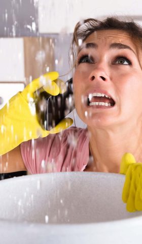 Water Ceiling Leak. Holding Bucket. Flood Emergency