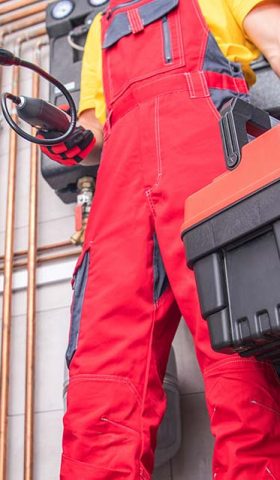 Residential Furnace System Technician at Work. Check and Repair HVAC Systems. Worker with His Toolbox. Industrial Theme.