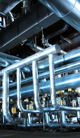 Equipment, cables and piping as found inside of  industrial power plant